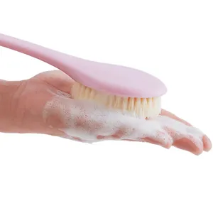 Long handled bath brush with soft bristles for body exfoliating, pink handle and rich foam.