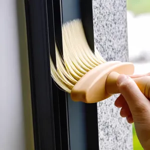 Window track cleaning brush with soft bristles and wooden handle for home gap dust removal.