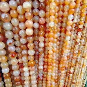 Detail view of colorful natural striped agate round beads strands for DIY jewelry making.
