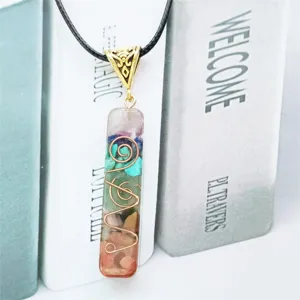 Macro detail of natural 7-chakra crushed stone pendant with copper wire wrap