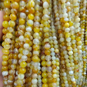 Yellow striped agate gemstone beads detail shot, perfect for DIY jewelry making and crafts.