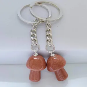 Close-up of sparkling goldstone mushroom keychain charm, perfect bag accessory detail view.