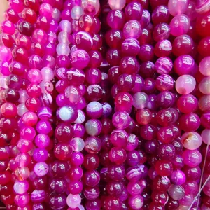Purple striped agate loose round beads detail, ideal for DIY handmade jewelry and beaded necklaces.