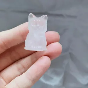 Closeup detail of the handcrafted crystal cat carving, showing smooth gemstone texture and polish.
