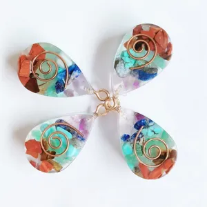 Handmade crystal resin teardrop pendant with colorful crushed stones and copper wire spiral.