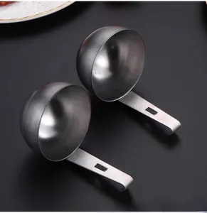 Stainless steel hanging egg poacher spoon detail, practical kitchen tool for boiled eggs.