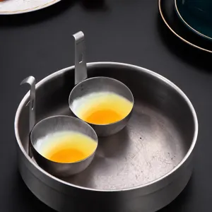Stainless steel egg poacher hanging design kitchen tool for easy breakfast cooking.