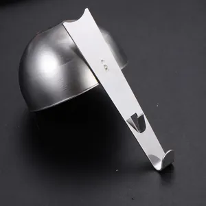 Stainless steel egg poacher spoon hanging tool for breakfast kitchen cooking preparation.