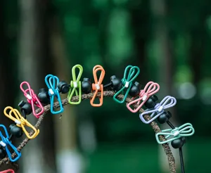 Portable travel clothesline with colorful clips and elastic rope for outdoor camping.