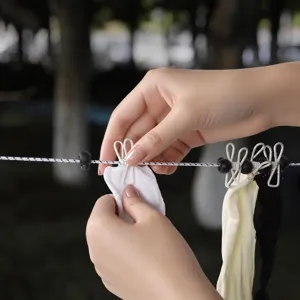 Portable travel clothesline with windproof clips and fixed beads for outdoor hotel use