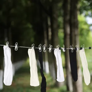 Portable travel clothesline for outdoor camping and hotel use, windproof elastic hanging rope.