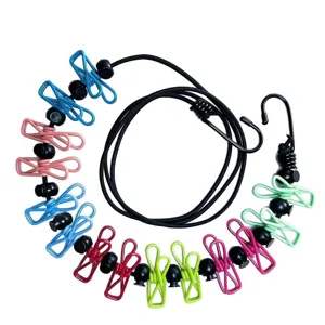 Portable travel clothesline with colorful clips and elastic bungee cord for outdoor use.