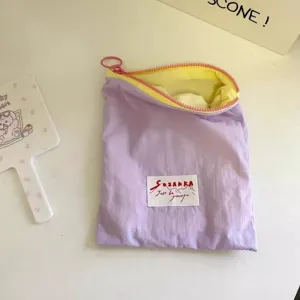 Macaron color-blocking cosmetic bag, portable zipper makeup pouch for lipstick and daily storage.