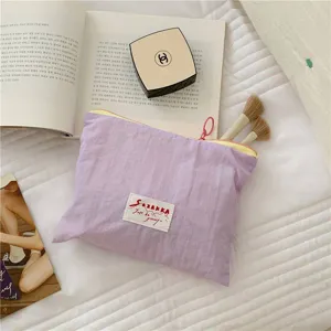 Portable purple cosmetic storage bag, aesthetic macaroon color zipper makeup organizer for daily travel.