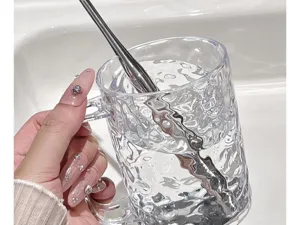 Transparent textured rinse cup detail, unique water ripple design with smooth handle.