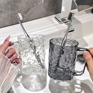 Clear luxury couple mouthwash cups with handle and toothbrush set for modern bathroom.