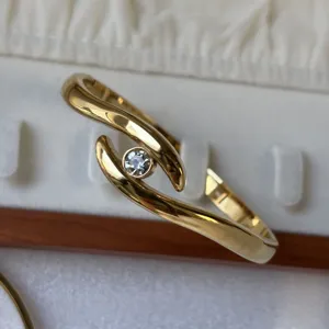 Bracelet jonc élégant en acier inoxydable doré poli avec un cristal scintillant
