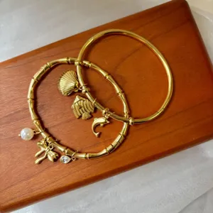 18K gold plated stainless steel bangles set with sea-themed charms and bamboo texture detail