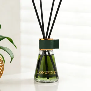 Reed diffuser bottle with green liquid, black sticks and leather collar for home fragrance decor.