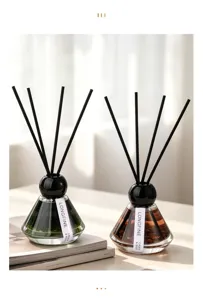 Glass reed diffuser set with black sticks and natural crystal stones for home fragrance decor.