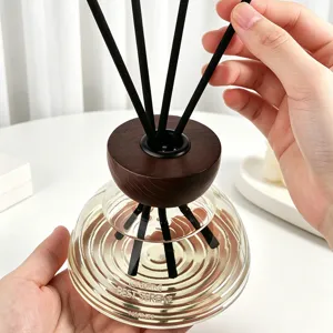 Modern home fragrance reed diffuser set with wooden cap and glass bottle for indoor decor.