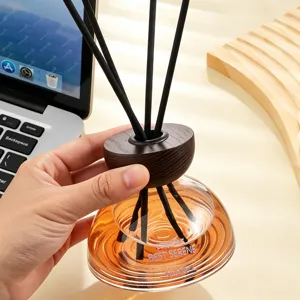 Modern home reed diffuser set with elegant glass bottle, wooden cap and natural black sticks.