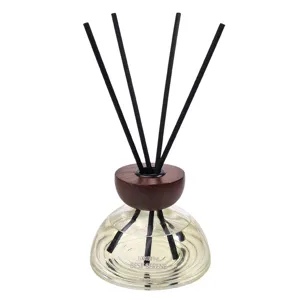 Glass reed diffuser bottle with wooden cap and black sticks for home fragrance and indoor decor.