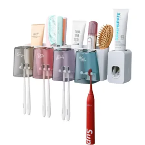 Juego de soporte para cepillos de dientes de pared con dispensador automático y tazas.