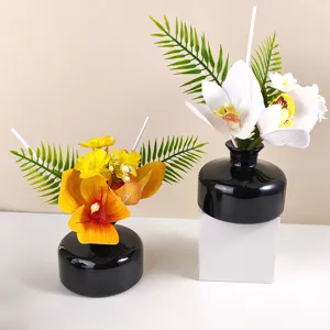 Artificial orchid flower diffuser set with black bottles for home decor, elegant floral arrangement
