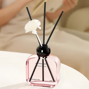 Pink glass reed diffuser bottle 150ml with black sticks and flower for home air freshener.