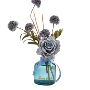Decorative reed diffuser with artificial grey rose and chrysanthemum flowers for home room decor.