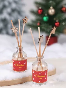 Vue détaillée de la bouteille de diffuseur de parfum de Noël avec bâtons en bois et neige.
