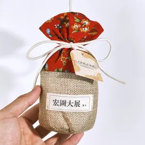Detailed view of traditional Chinese style fabric sachet bag with floral pattern and burlap base.