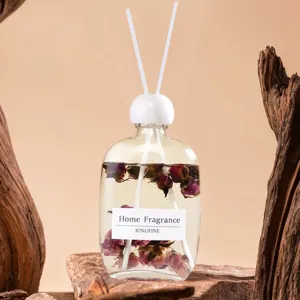 Nahaufnahme einer transparenten Glas-Duftstäbchen-Flasche gefüllt mit Trockenblumen.