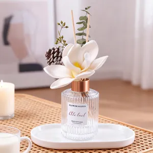Home reed diffuser set with elegant white flower and glass bottle for living room decor.