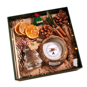 Christmas scented candle gift box set with natural pine cones, dried oranges and lights.