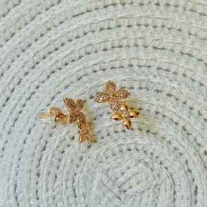 Rose gold four-leaf clover stud earrings with sparkling cubic zirconia floral design.