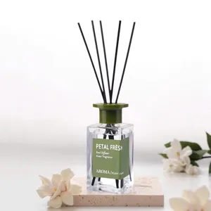 Elegant home reed diffuser with glass bottle and black sticks, perfect for desktop decoration.