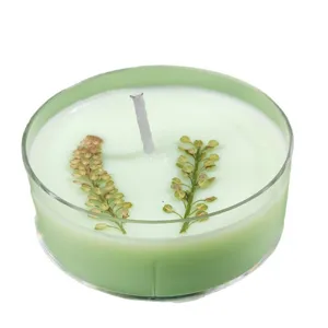 Green scented candle with dried flowers in clear cup for home decor relaxing aromatherapy gift
