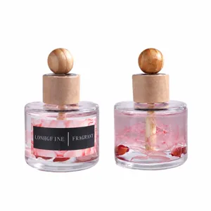 Glass car air freshener with wooden ball lid and pink floating flower diffuser oil bottle