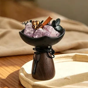 Detail view of crystal aroma diffuser ornament with natural stones, wood base, and dried decor.