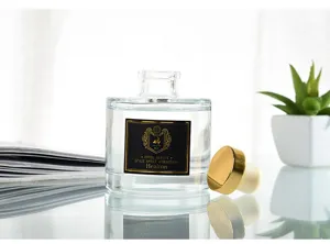 Glass aroma diffuser bottle detail with gold cap and black label for home decor.
