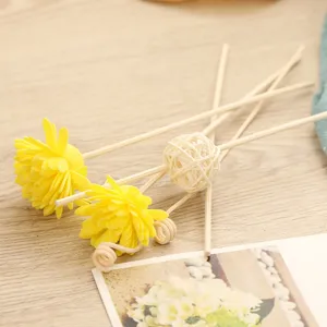 Flameless aroma diffuser sticks set with yellow flower and rattan ball for home decoration.