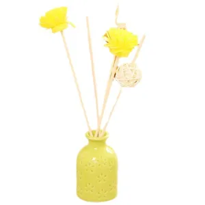 Fresh style flameless aroma diffuser set with green ceramic bottle and yellow flower reed sticks.