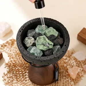 Volcanic stone essential oil aromatherapy diffuser with natural crystal stones and wood base.