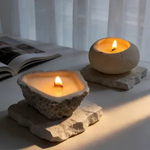 Concrete scented candle with wooden wick, stone-textured vessel for home decor relaxation.