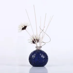 Blue mosaic glass aroma diffuser bottle set with decorative reed sticks for home interior decor.