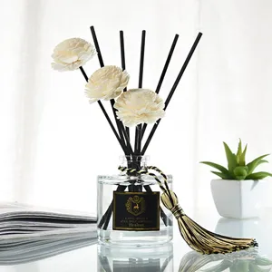 Reed diffuser set with wooden flower sticks and golden tassel for home fragrance decor gift.