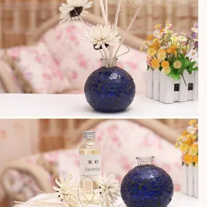 Blue mosaic glass aromatherapy bottle set with floral diffuser sticks and essential oil.