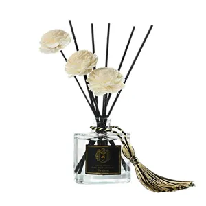 Aromatherapy reed diffuser bottle with sola flowers and black sticks for home and room decor.